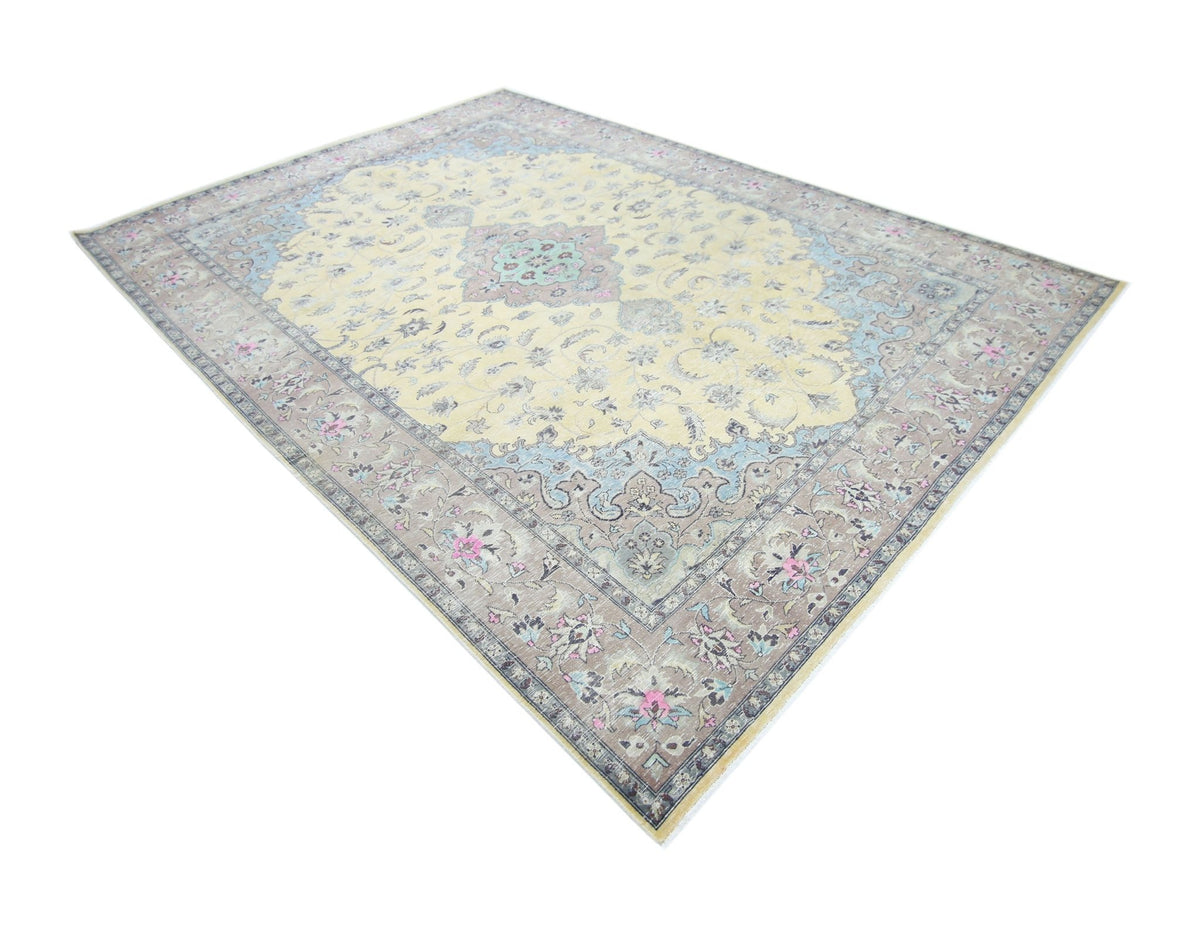 Vintage Pakistani rug with a cream central medallion, blue floral motifs, and a muted grey-brown border.