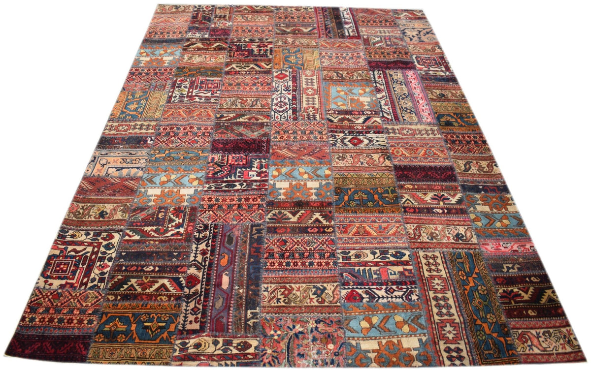 A handmade vintage patchwork rug featuring a colorful array of wool patterns on a cotton base.