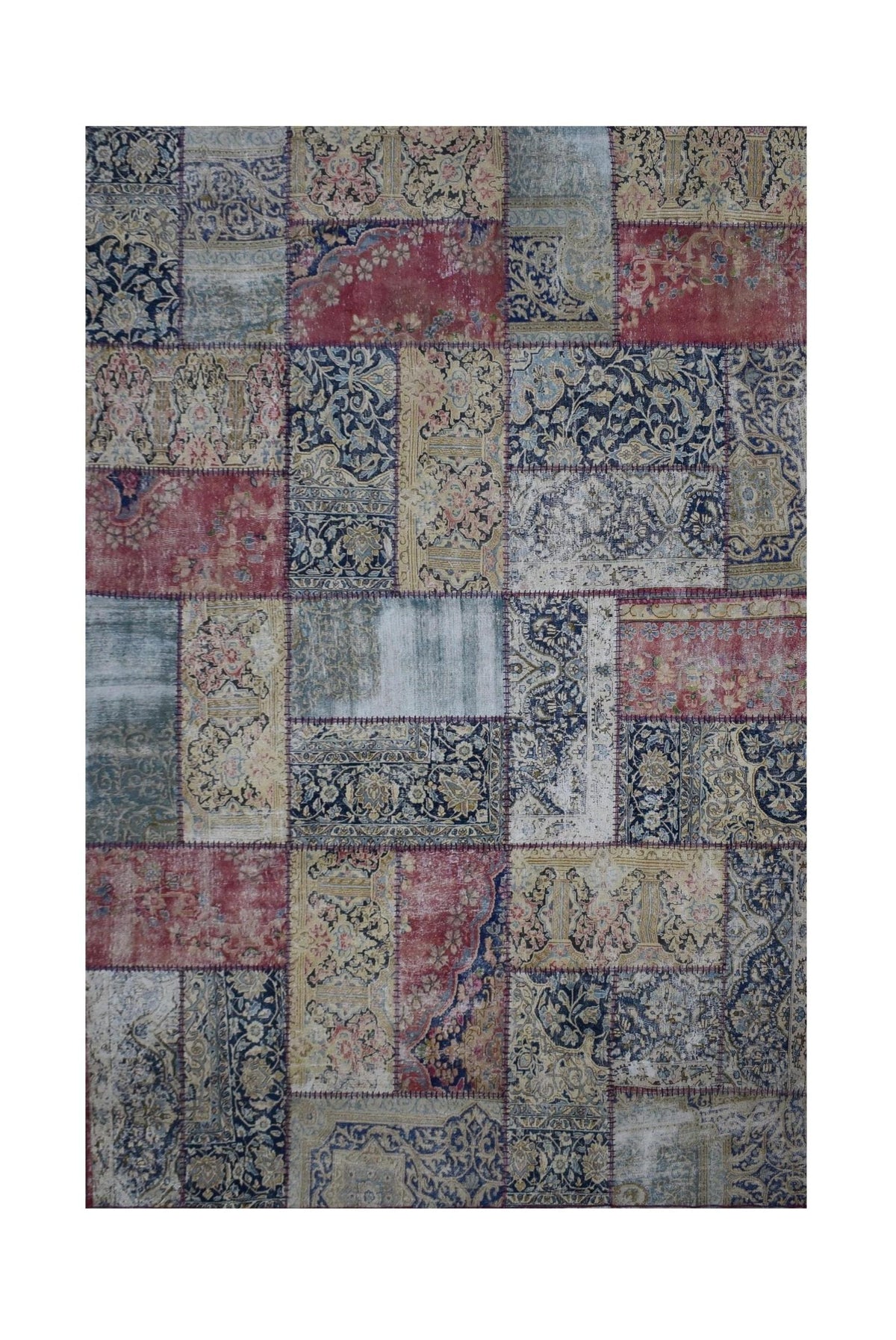 A handmade patchwork rug featuring a vintage-inspired collage of floral and ornate patterns.