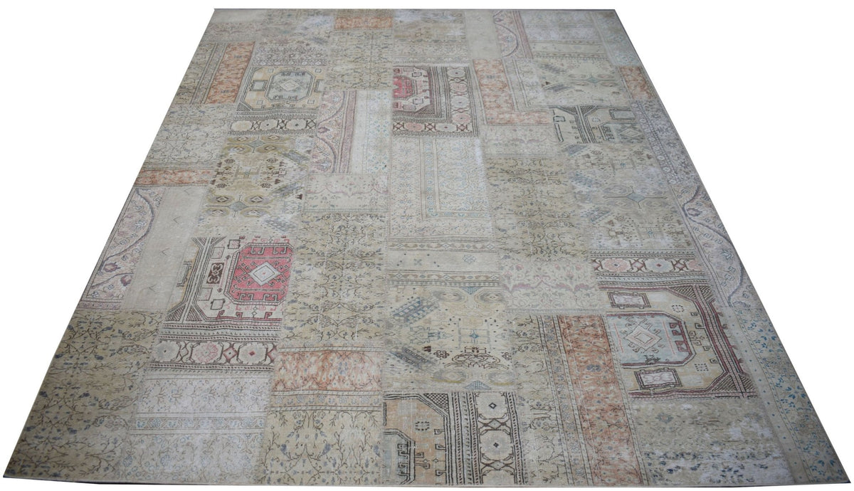 A handmade vintage patchwork rug featuring a neutral color palette with faded geometric patterns.