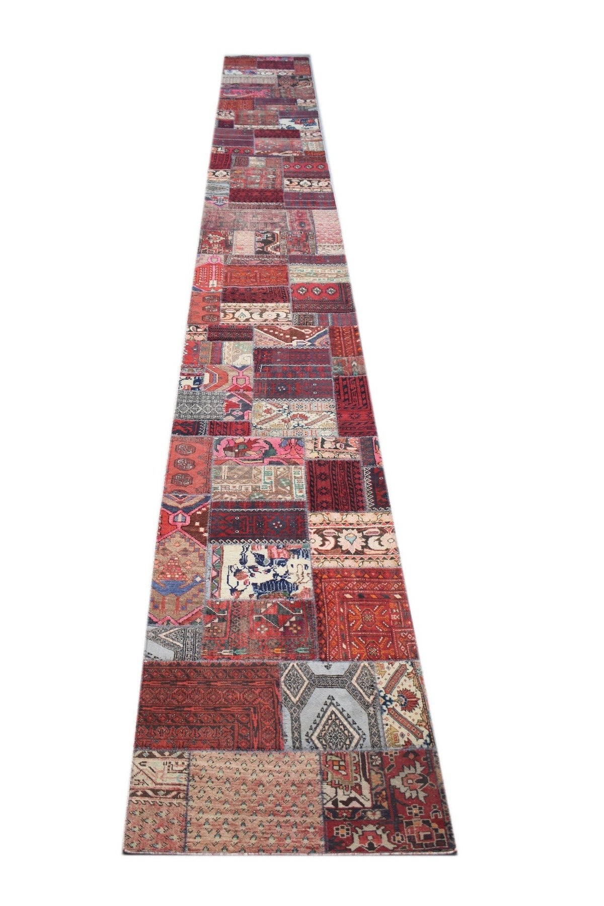Hand-knotted vintage Persian patchwork runner featuring a vibrant, multi-coloured geometric design in a long rectangular format.