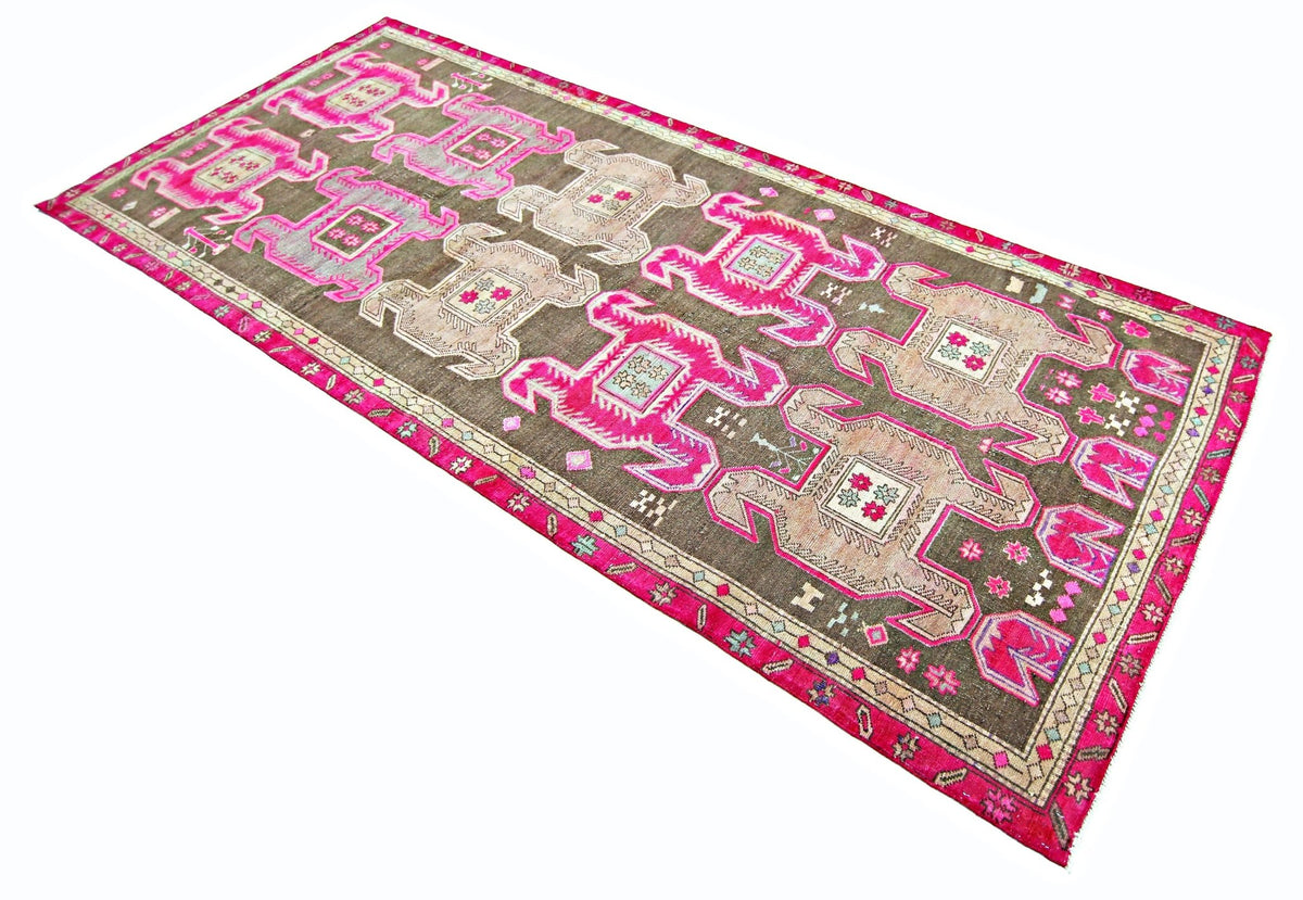 Vintage Persian Ardabil wool runner featuring geometric motifs in vibrant pink, brown, and cream on a white background.