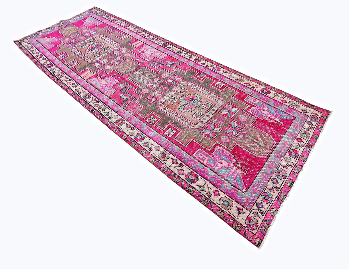 Vintage Persian Ardabil wool runner featuring geometric patterns in vibrant pink, grey, and blue on a white background.