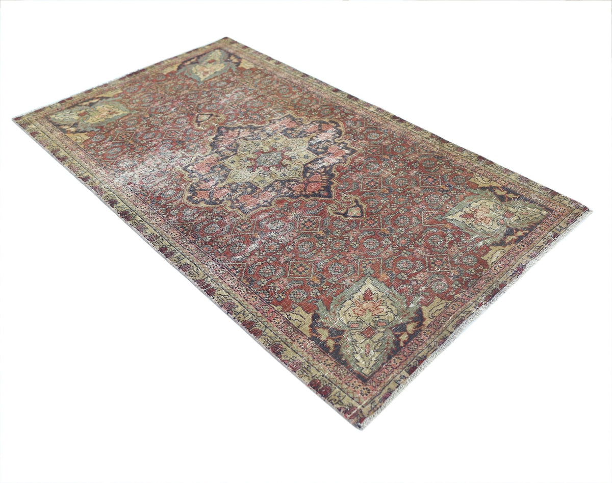 A vintage handmade Persian Bakhtiari rug featuring a traditional floral pattern in red and green.