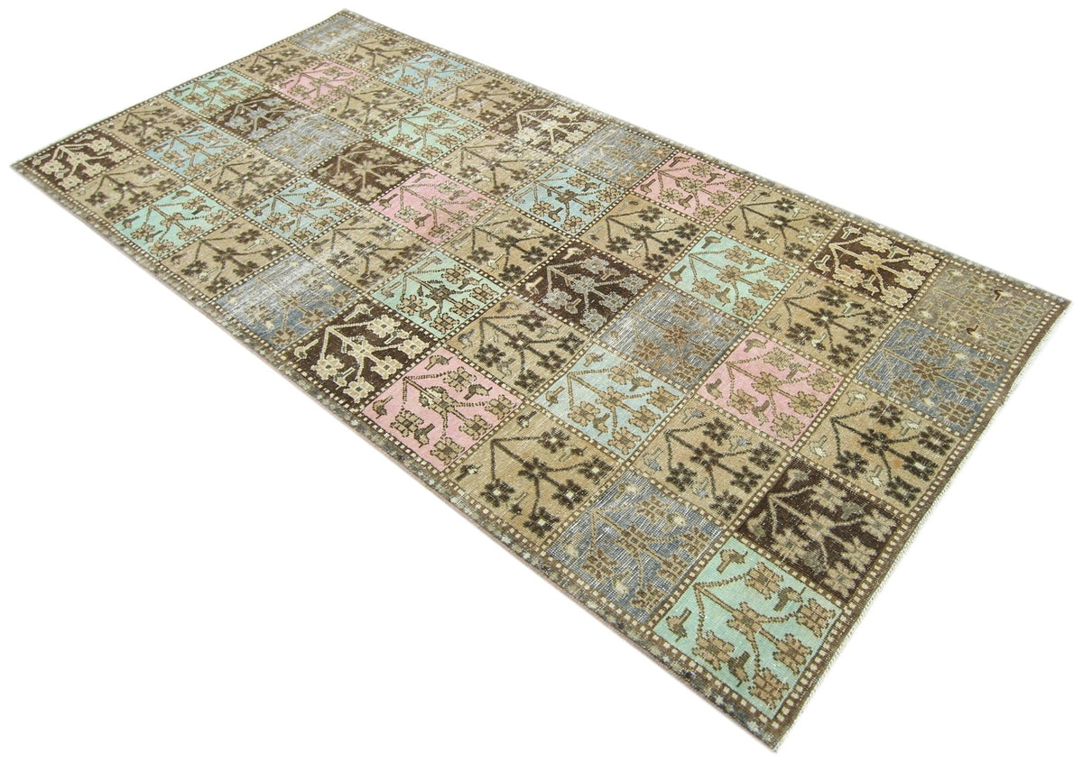 Vintage Persian Bakhtiari rug featuring a Khesti garden panel pattern in soft pink, blue, and earthy brown tones.