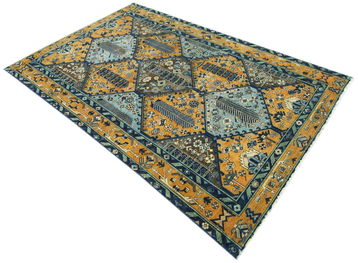 Vintage Persian Bakhtiari rug with a blue and gold Khesti garden panel pattern featuring intricate floral motifs.