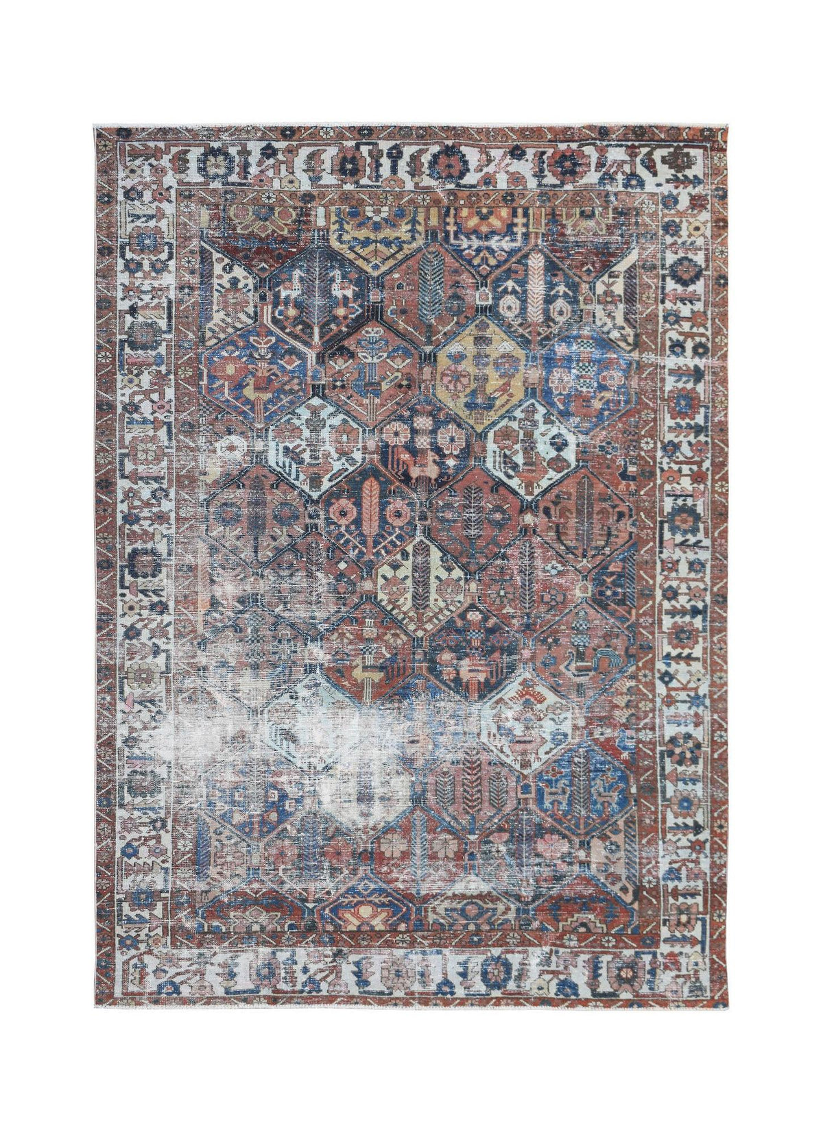 A vintage Persian Bakhtiari rug featuring a distressed geometric garden pattern in muted tones.