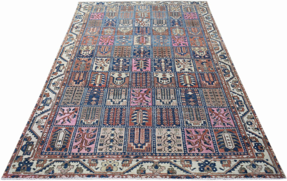 A vintage Persian Bakhtiari rug featuring a colorful grid of geometric and floral motifs.