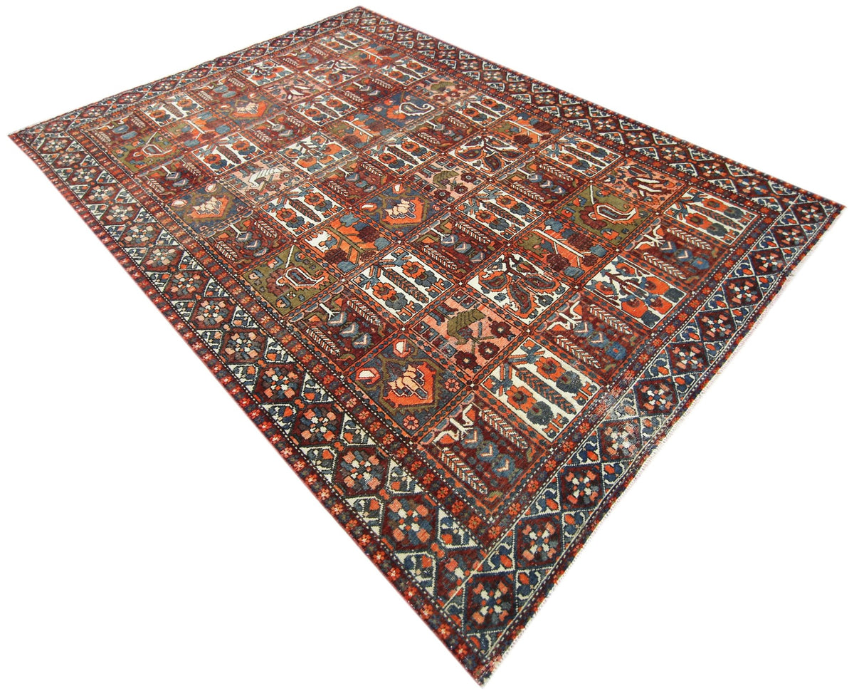 Vintage Persian Bakhtiari rug featuring a multi-coloured Khesti garden panel design with intricate floral motifs.
