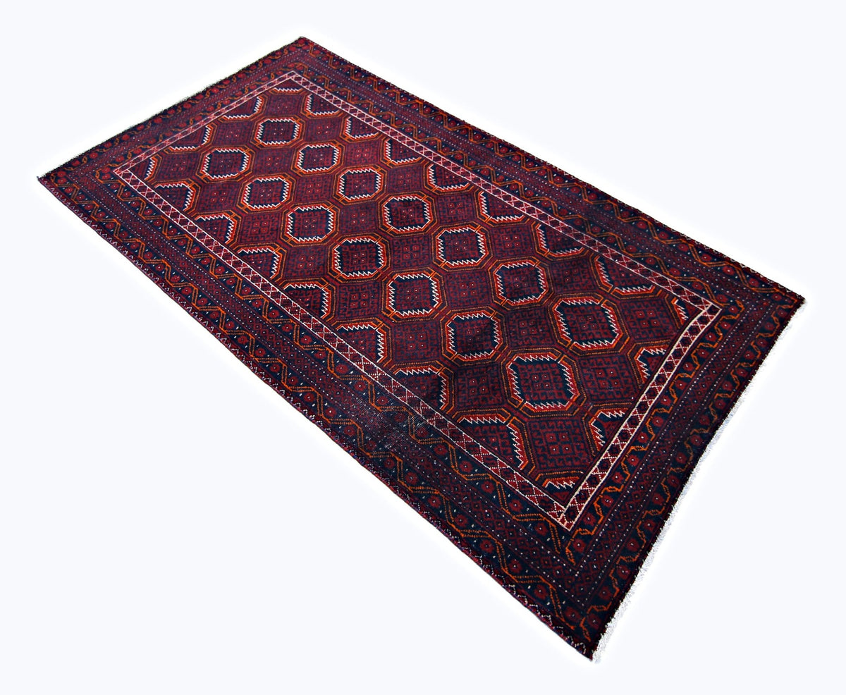 Hand-knotted Persian Baluch rug featuring geometric medallions in deep earthy red and navy tones with a wool fringe.