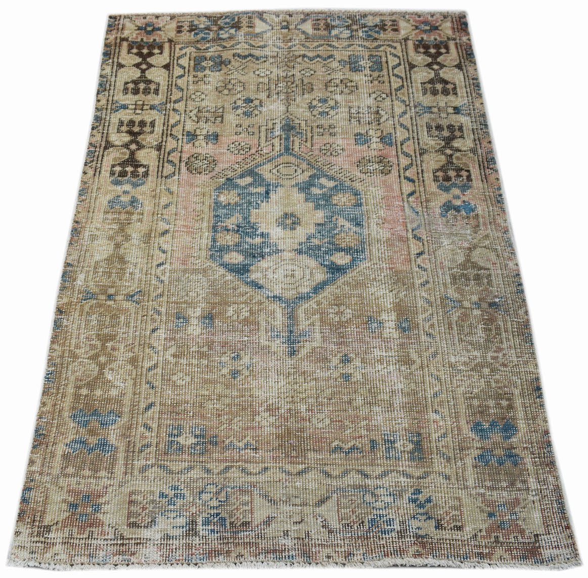 A vintage handwoven Persian Hamadan rug featuring a central blue medallion on a beige field.