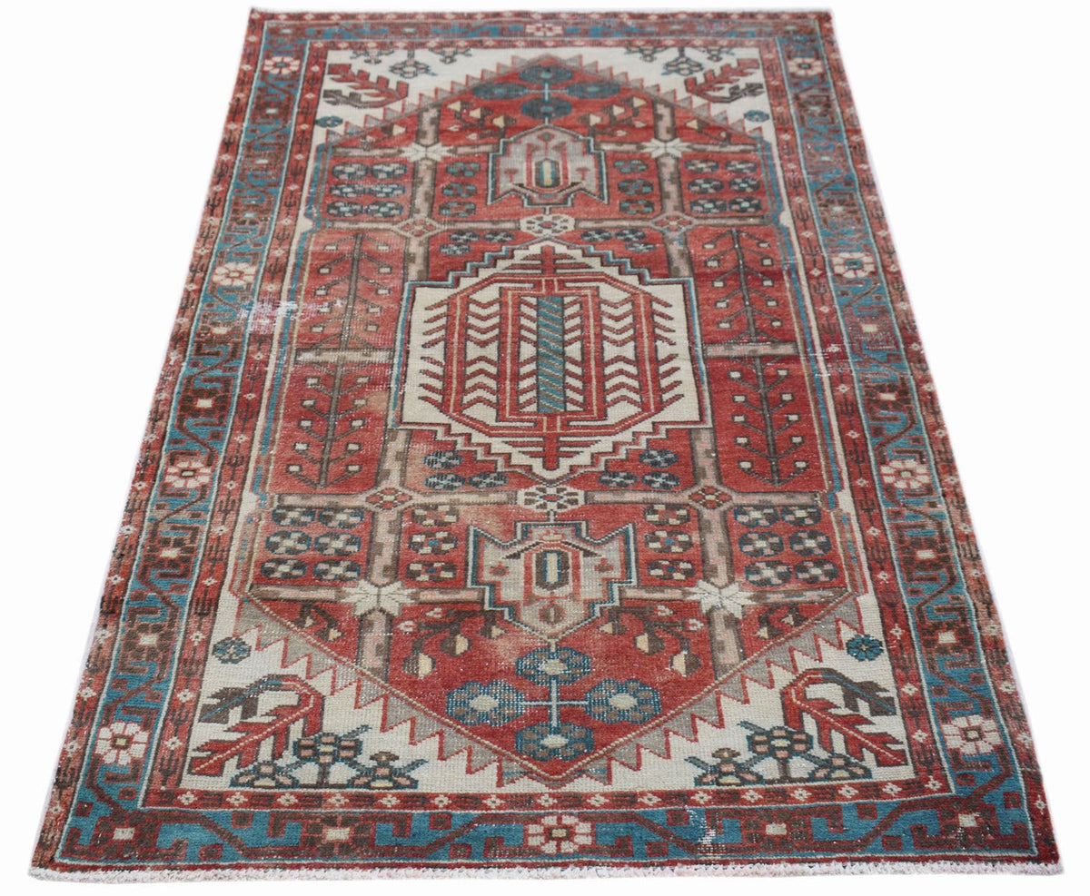 A vintage handwoven Persian Hamadan rug featuring a geometric medallion in red, blue, and cream.