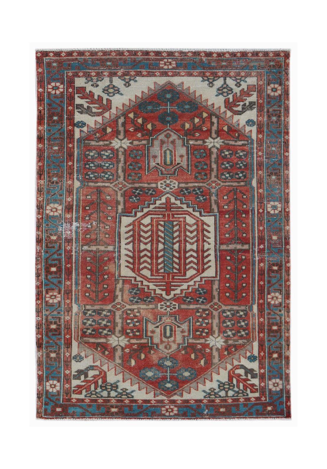 A vintage handwoven Persian Hamadan rug featuring a geometric medallion in red, blue, and cream.