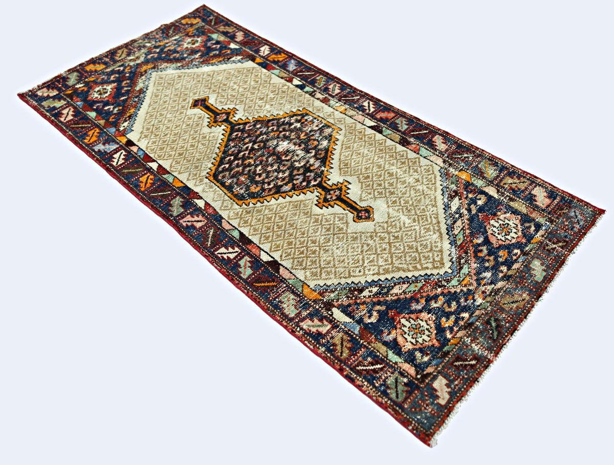A vintage handmade Persian Hamadan rug featuring a central medallion on a beige diamond pattern.