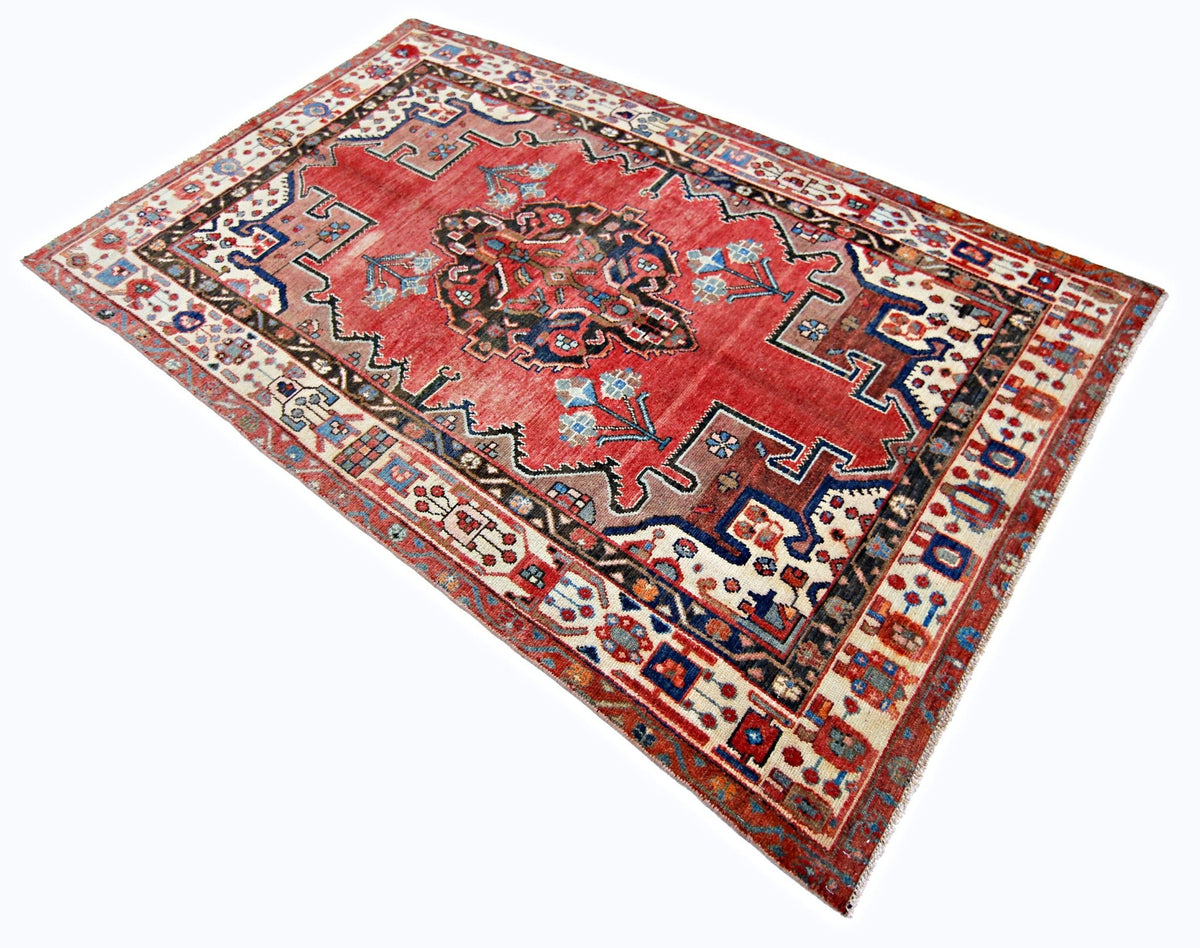 Hand-knotted vintage Hamadan rug in red with a central blue medallion and intricate cream and navy floral borders.