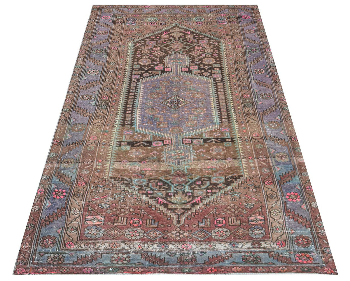 Hand-knotted vintage Hamadan rug featuring a central hexagonal medallion in brown, blue, and pink floral tribal motifs.