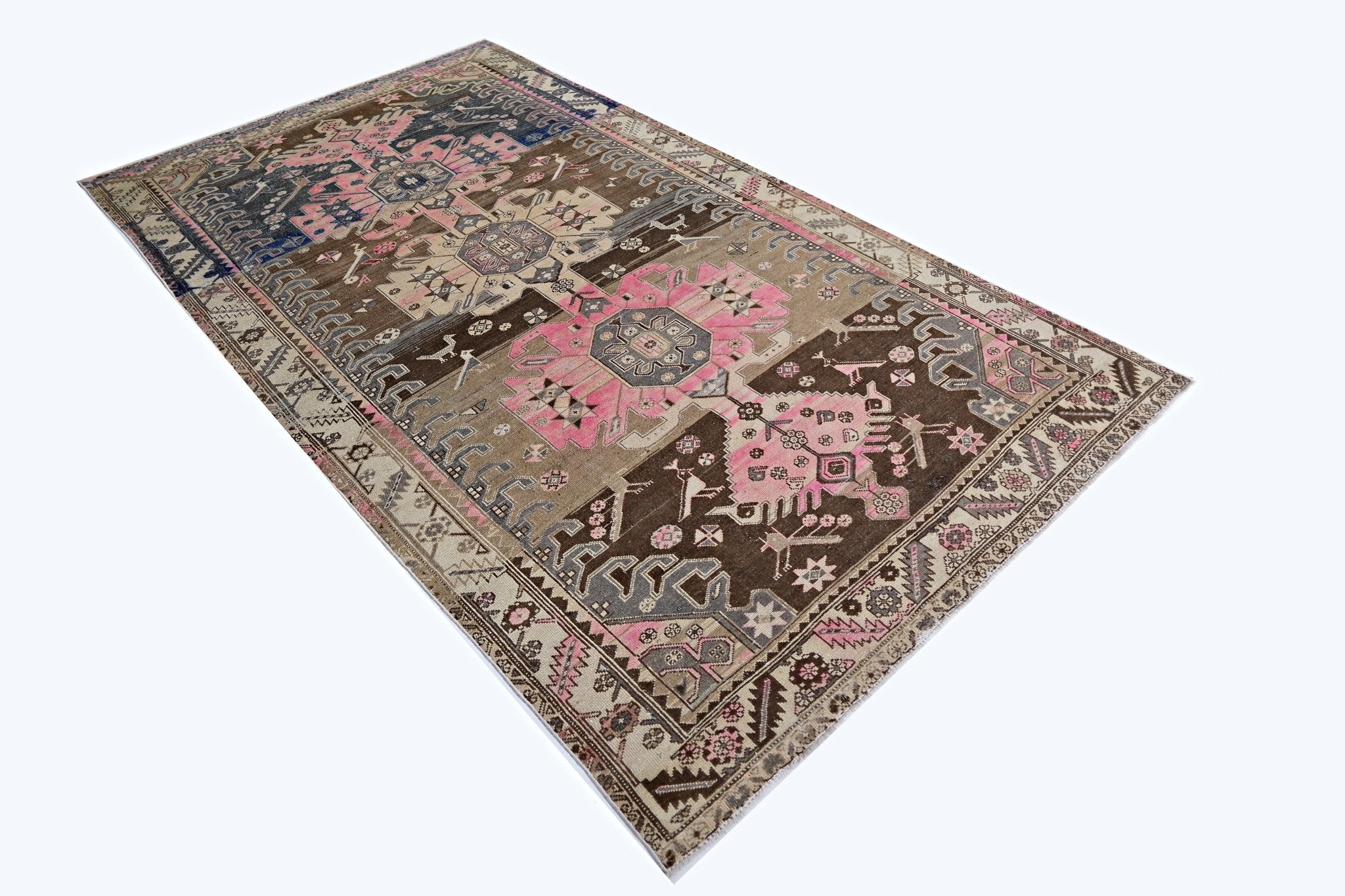 A vintage Persian Hamadan rug featuring geometric floral patterns in pink, brown, and grey tones.