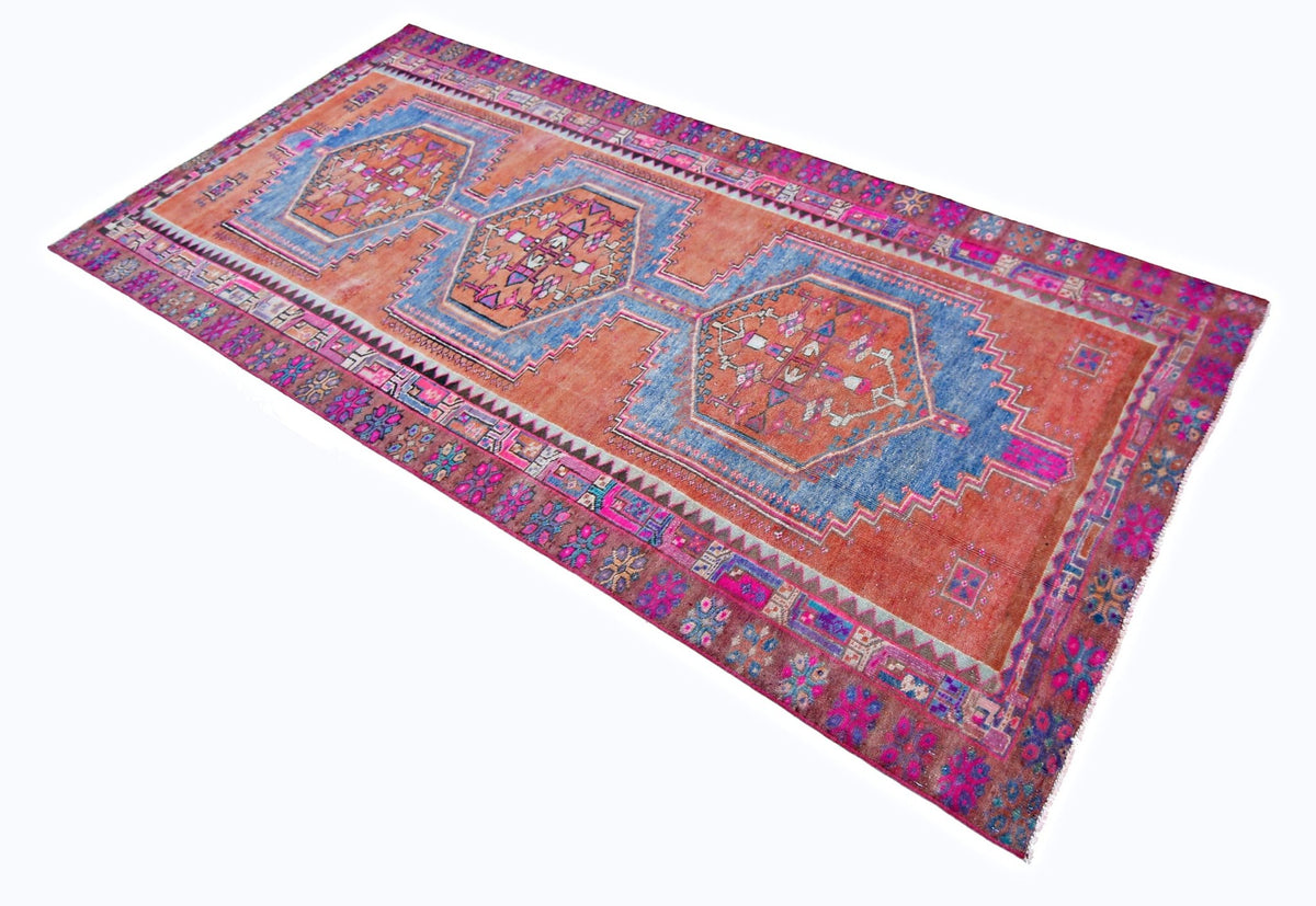 Hand-knotted vintage Hamadan runner in orange and blue with repeating hexagonal medallions and tribal floral borders.