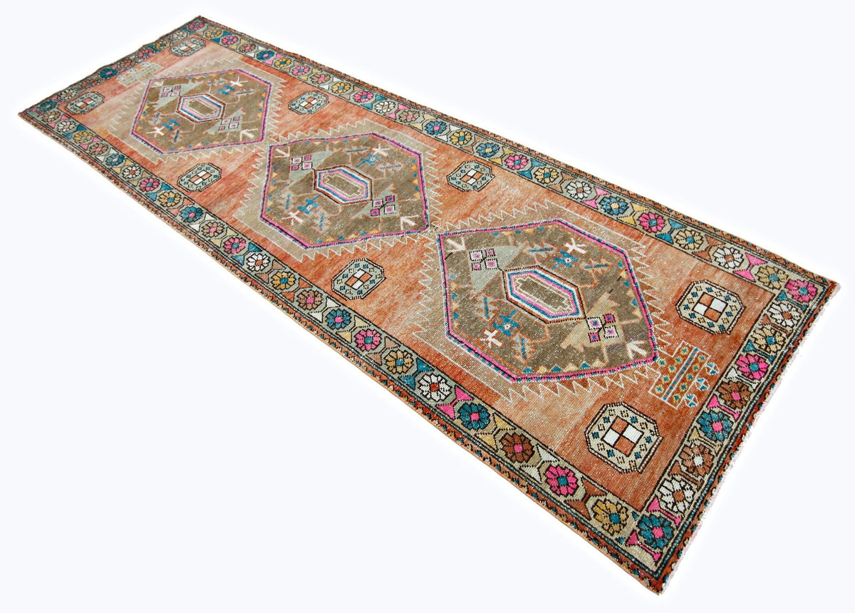 Hand-knotted wool Hamadan runner featuring orange tones, geometric medallions, and colourful floral tribal motifs.
