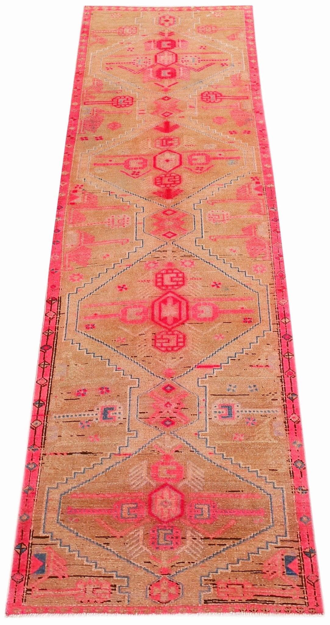 Hand-knotted vintage Hamadan runner in tan wool with repeating pink diamond medallions and angular tribal motifs.