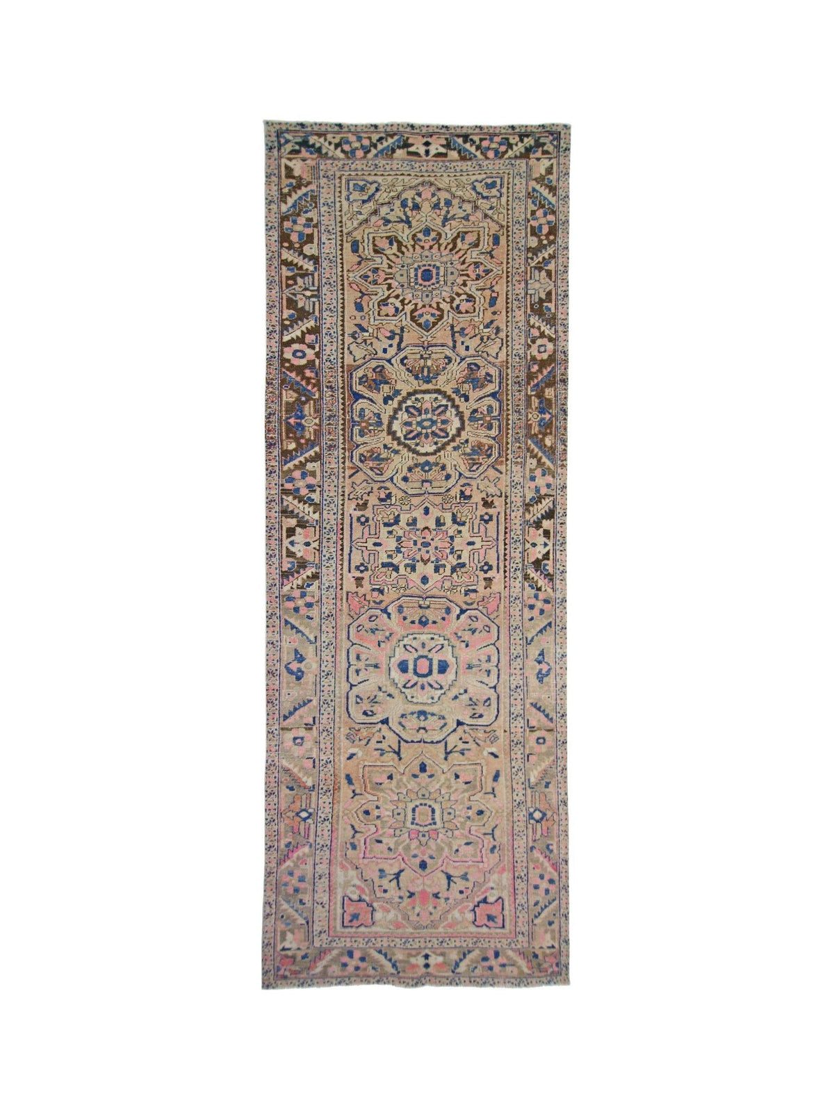 Vintage Persian Heriz runner with geometric medallions in soft pink, blue, and brown tones on hand-knotted wool.