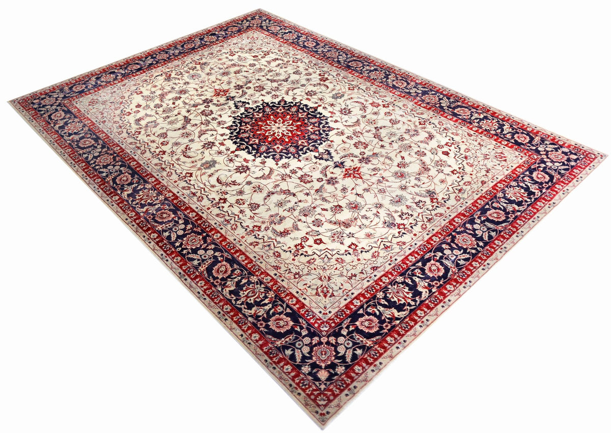 Vintage Isfahan rug with an intricate central medallion, floral arabesque patterns, and a deep red and navy blue border.