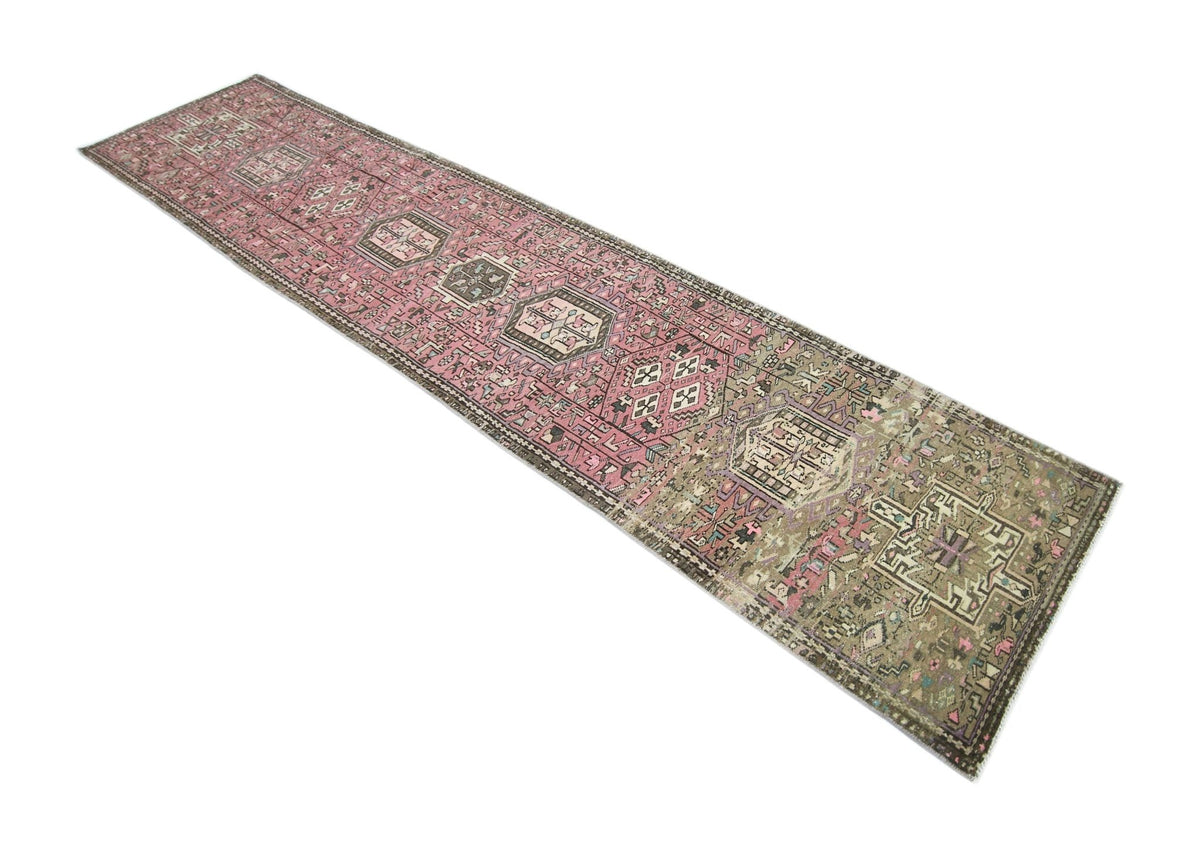 Hand-knotted vintage Karaja runner featuring stacked geometric medallions in faded pink, blue, and ivory wool.