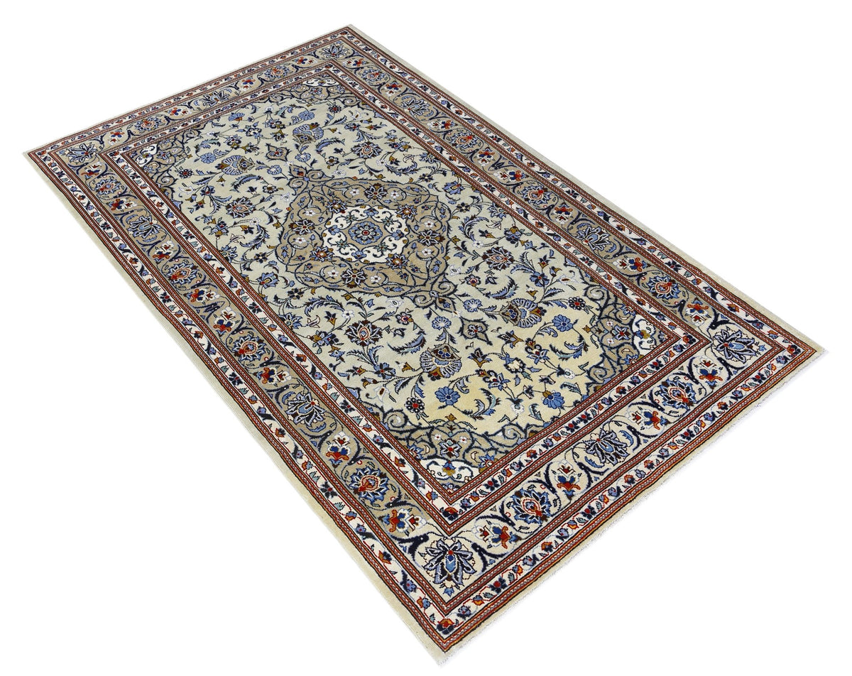Hand-knotted vintage Persian Kashan rug featuring a central medallion, floral motifs, and blue and red tones on cream.