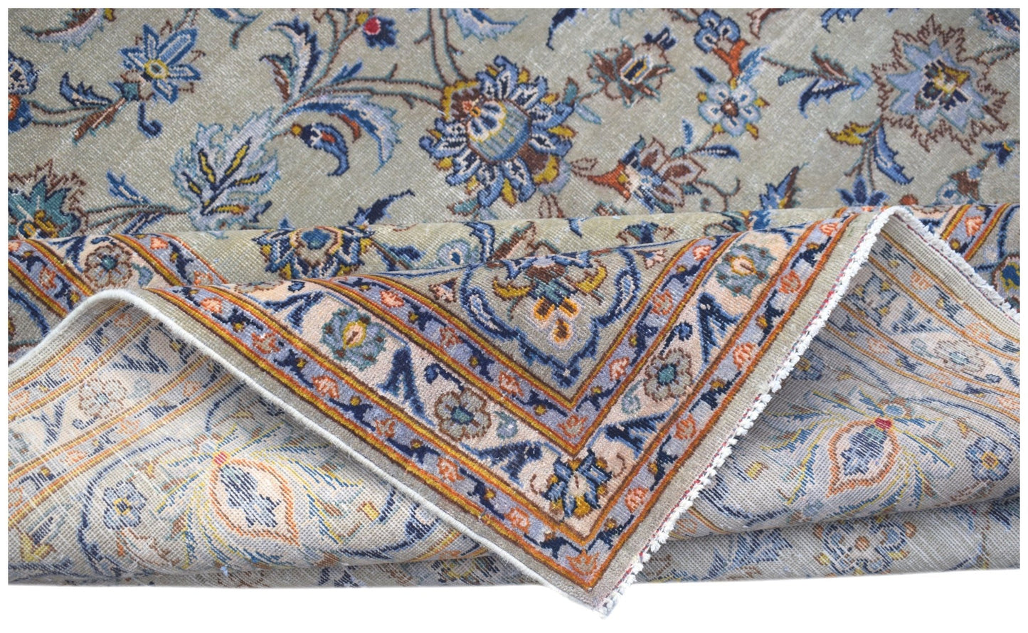 A vintage Persian Kashan rug featuring intricate floral patterns in blue, orange, and beige tones.