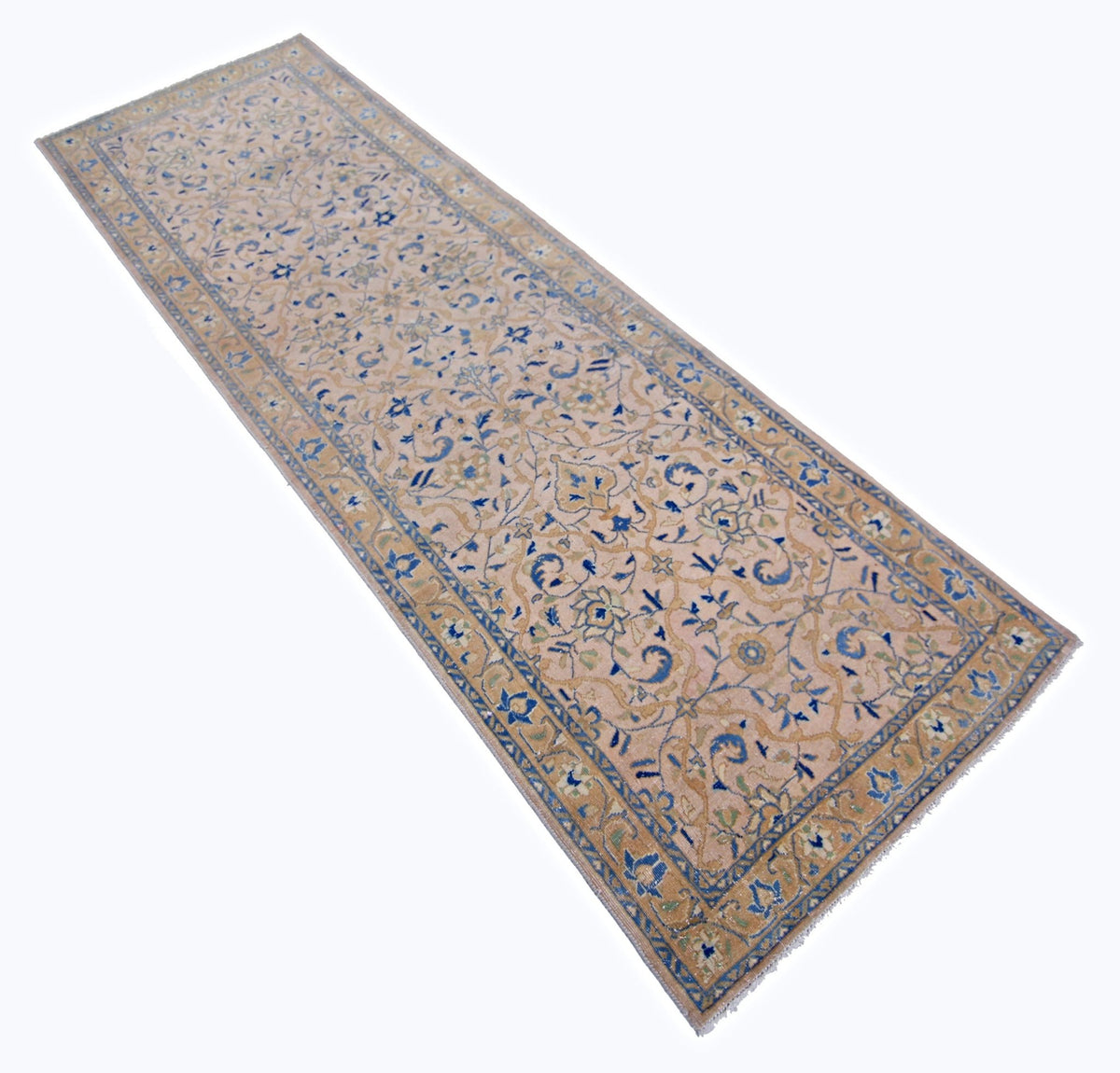 Vintage Persian Kashan runner with a soft pink field, blue floral arabesques, and a detailed decorative border.