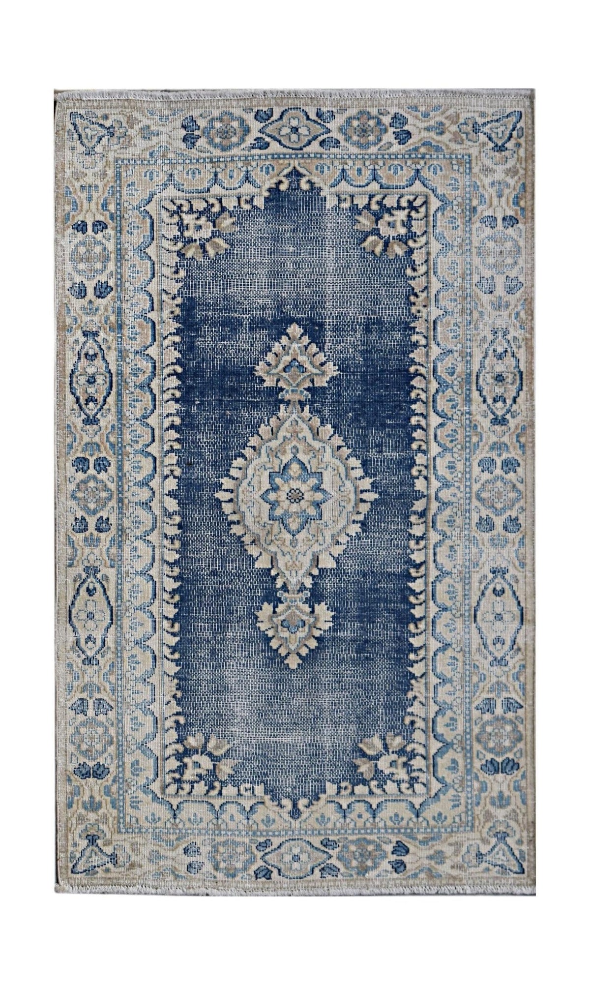Vintage Persian Kerman wool rug with a blue central medallion, intricate floral patterns, and a flat-pile finish.