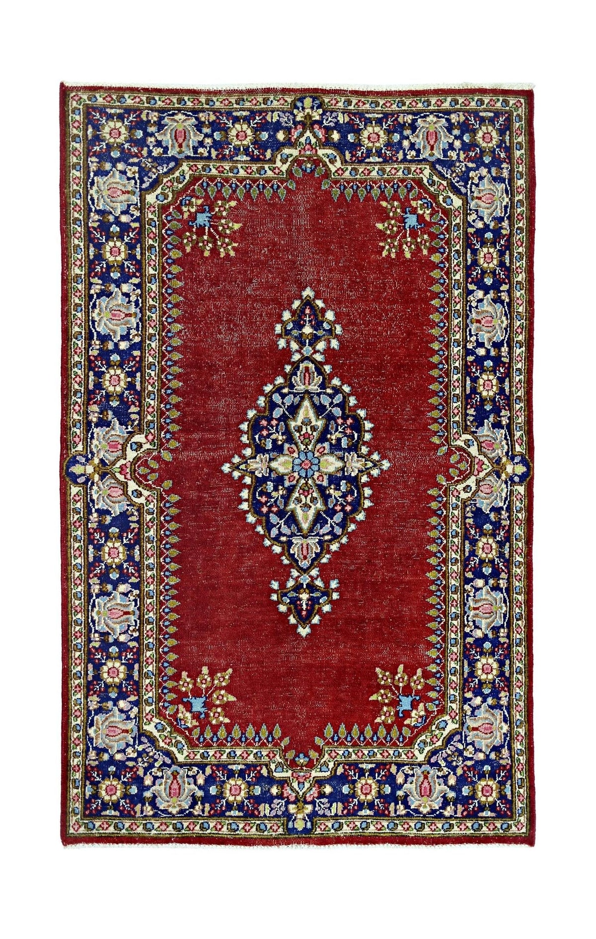 A vintage Persian Kerman rug featuring a central floral medallion on a red field with blue borders.