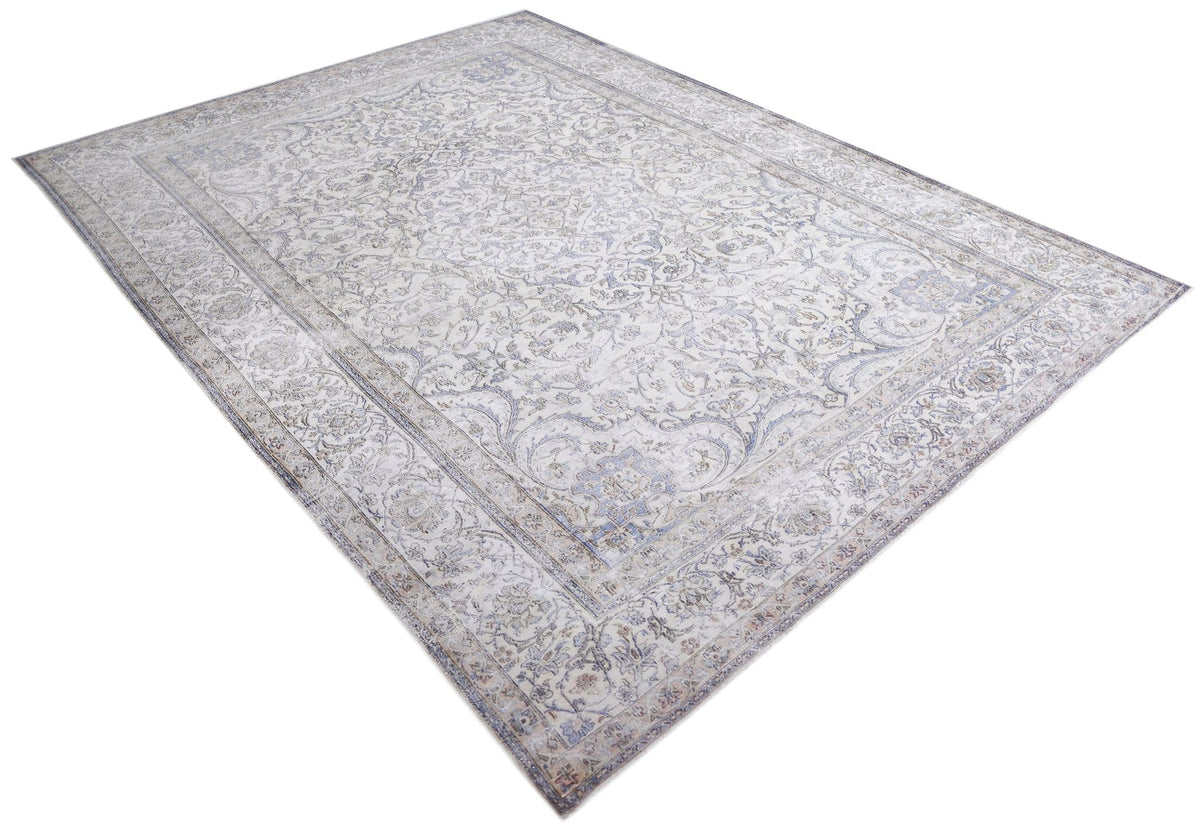 Vintage Kerman rug with intricate floral patterns in soft blue and cream tones on a hand-knotted wool pile.