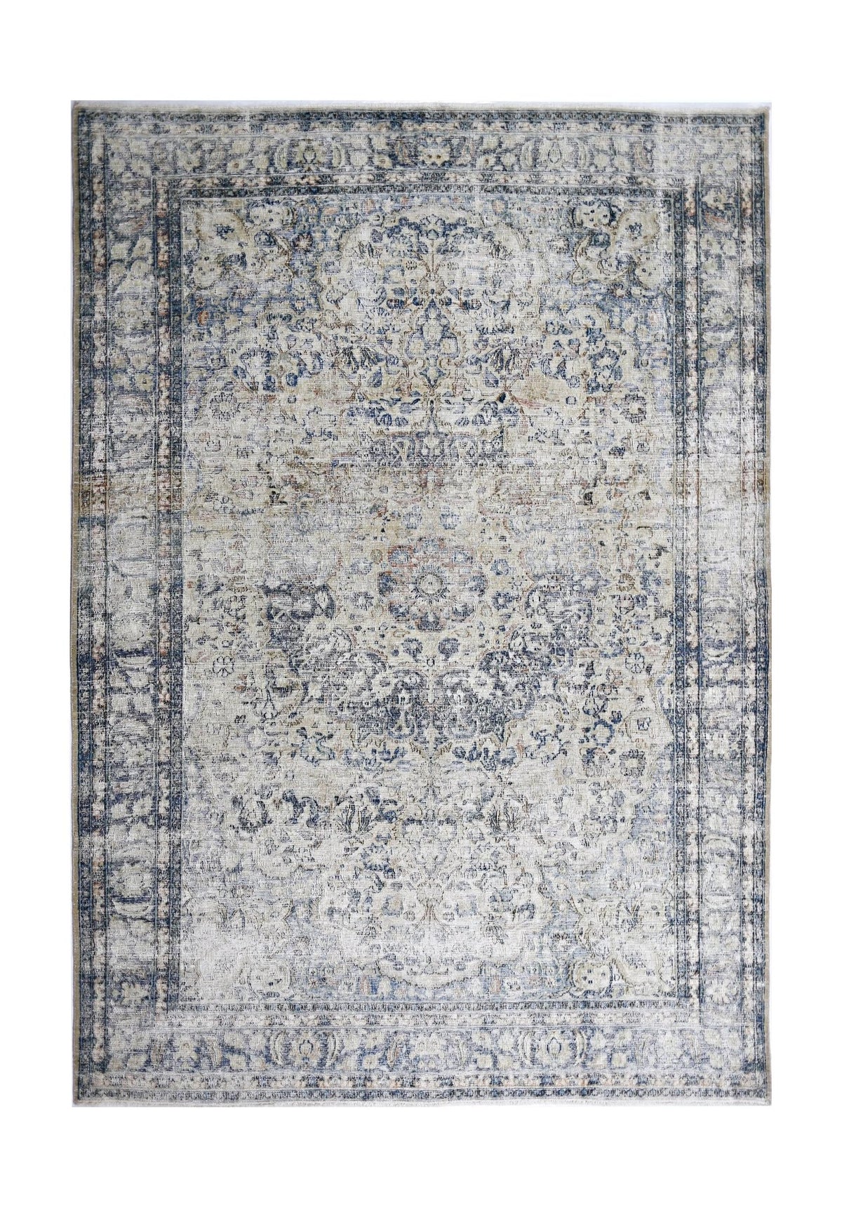 Vintage Persian Kerman wool rug with a faded blue and cream floral medallion pattern on a cotton foundation.
