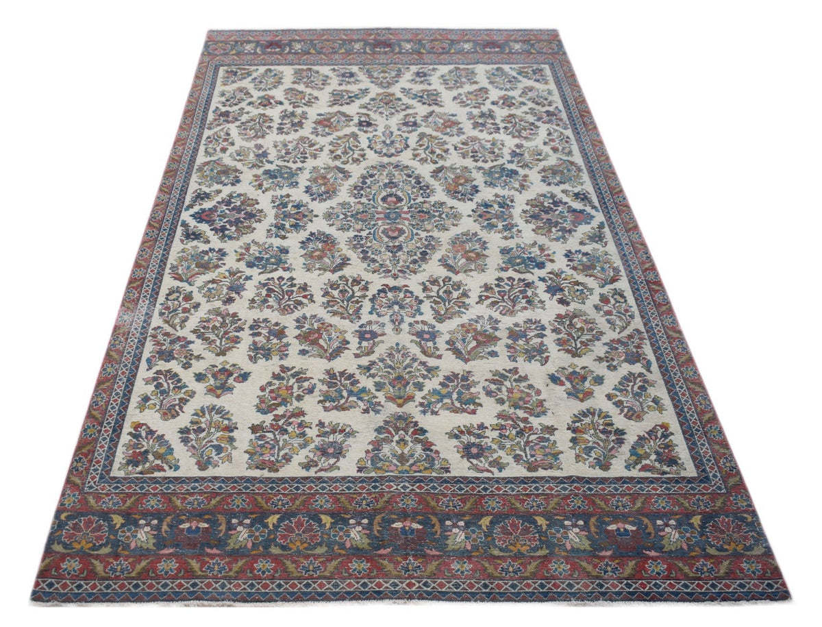 Hand-knotted vintage Persian Kerman rug with an ornate floral pattern, central medallion, and a deep red and blue border.