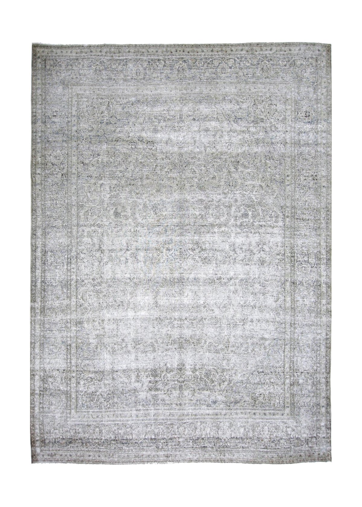 Full view of a vintage Persian Kerman rug featuring intricate grey and cream floral patterns on a low-pile wool surface.