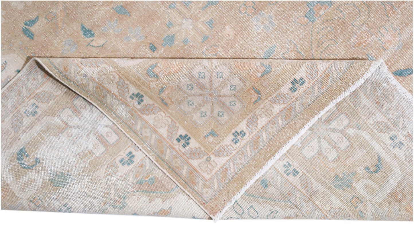 A vintage Persian Kerman rug featuring a soft beige palette with intricate floral medallion motifs.
