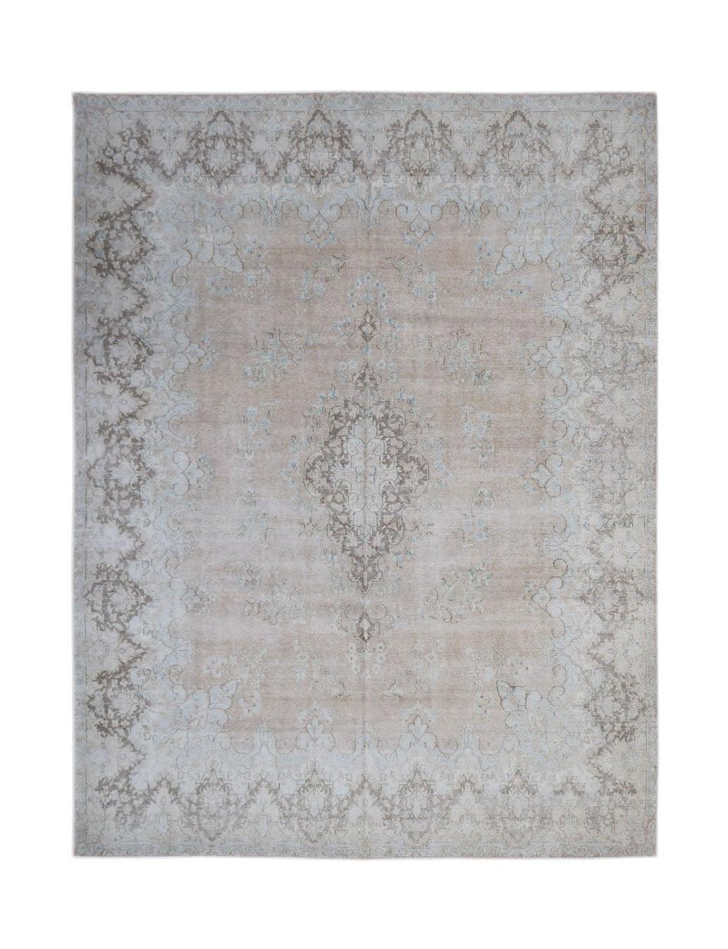 A vintage Persian Kerman rug featuring a central medallion and floral motifs in soft neutral tones.
