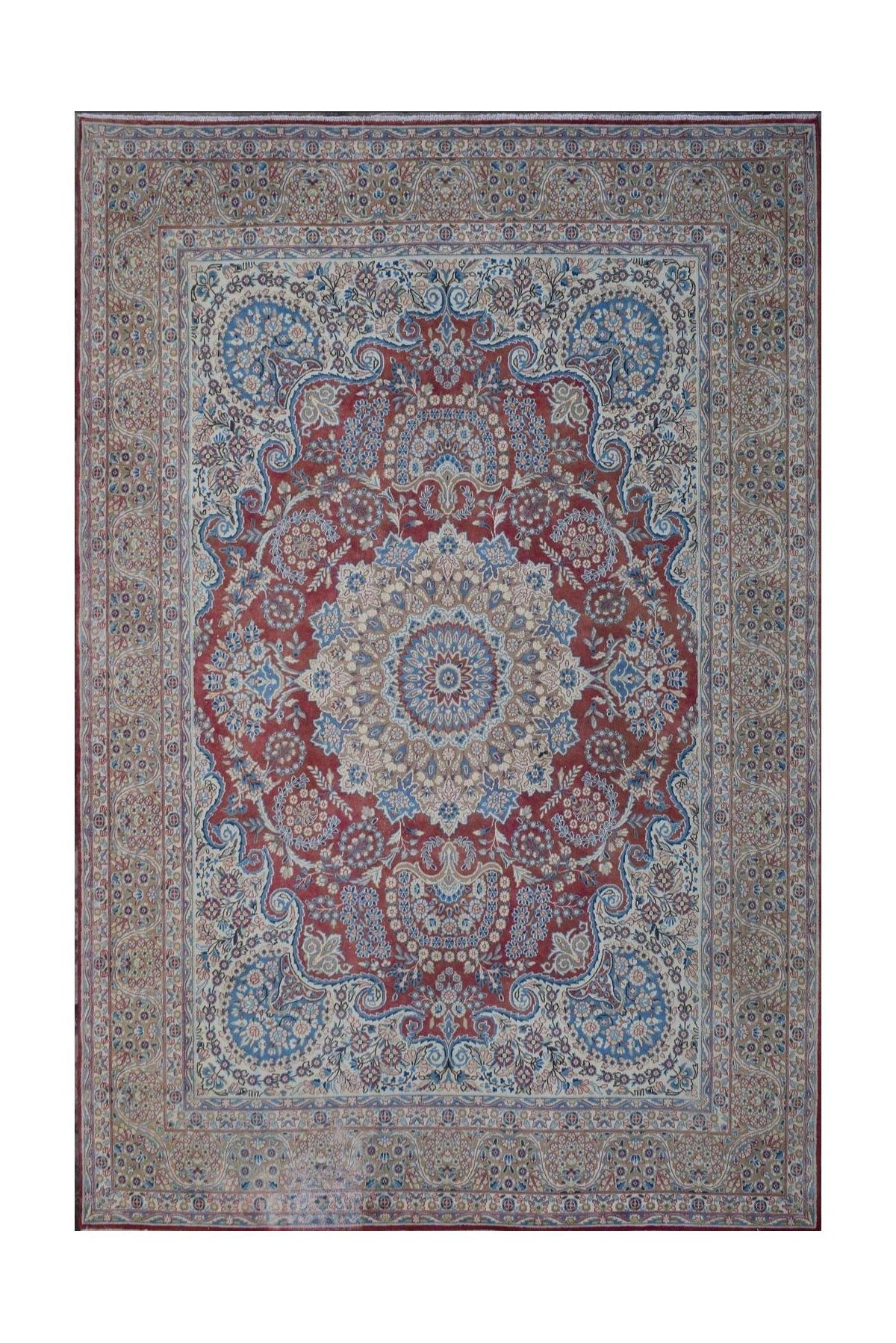 A vintage Persian Kerman rug featuring a central floral medallion on a red field with blue accents.