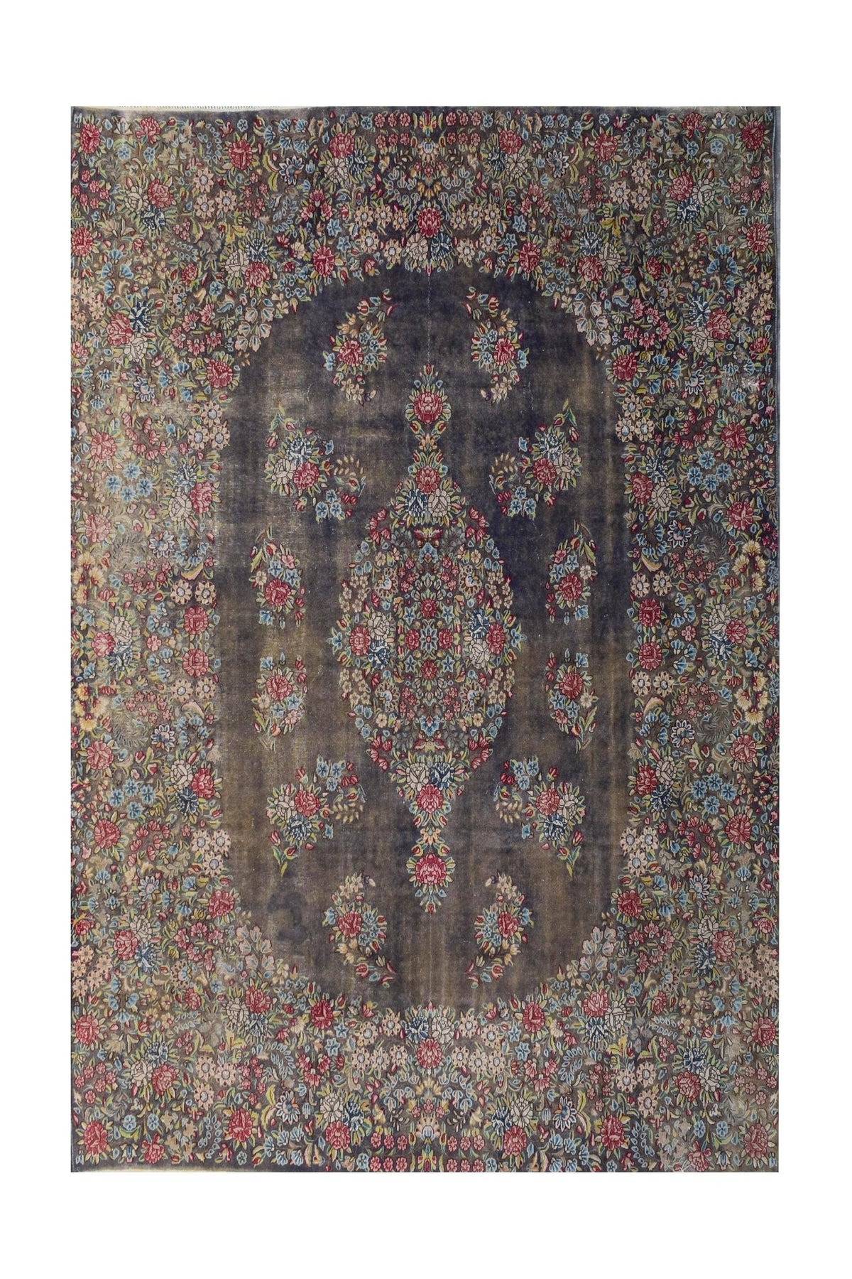 A vintage Persian Kerman rug featuring a central floral medallion on a dark, intricate field.