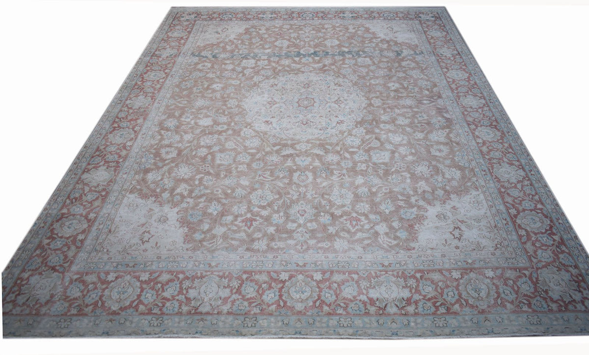 A vintage Persian Kerman rug featuring a central medallion and intricate floral patterns.