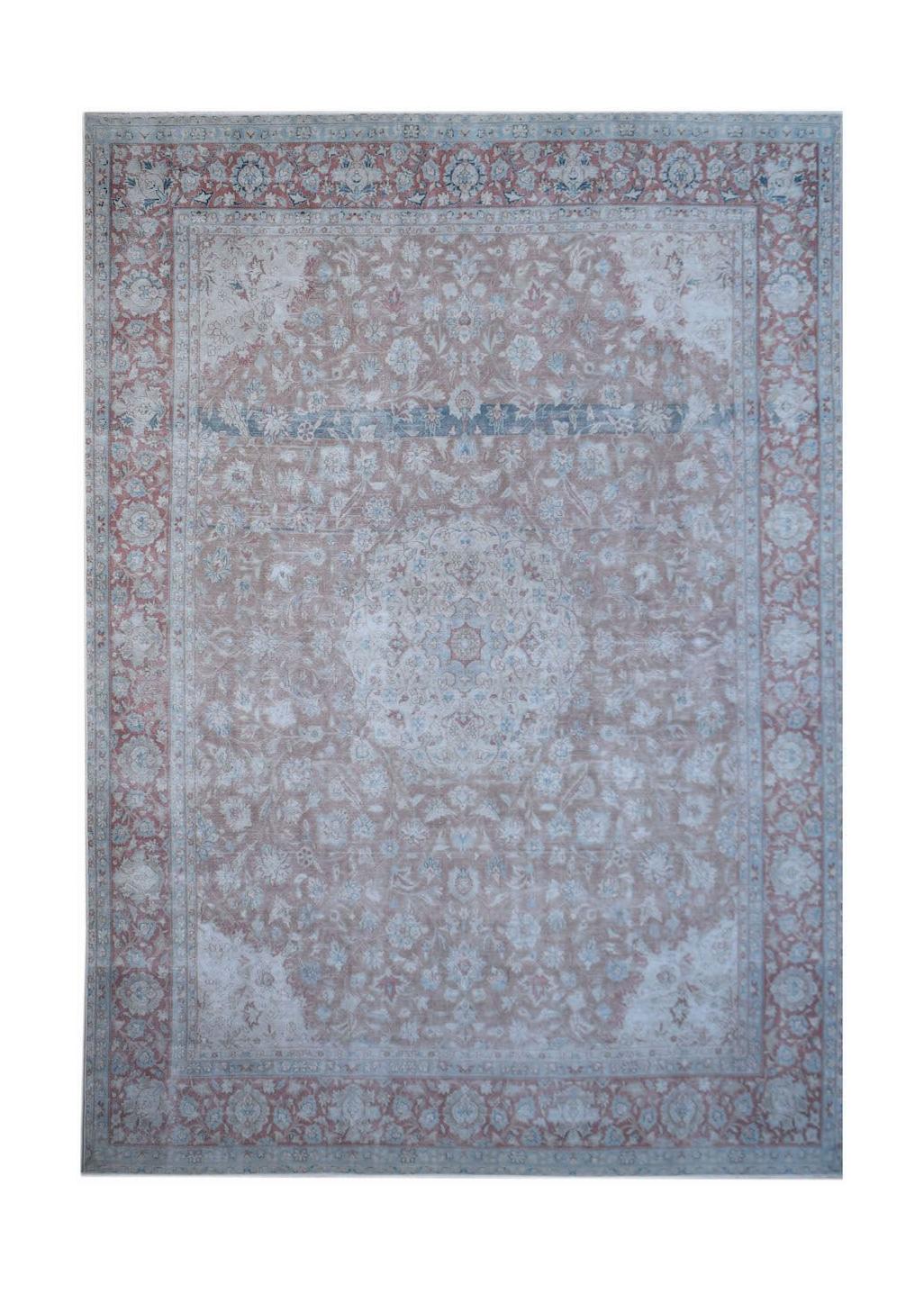 A vintage Persian Kerman rug featuring a central medallion and intricate floral patterns in soft hues.