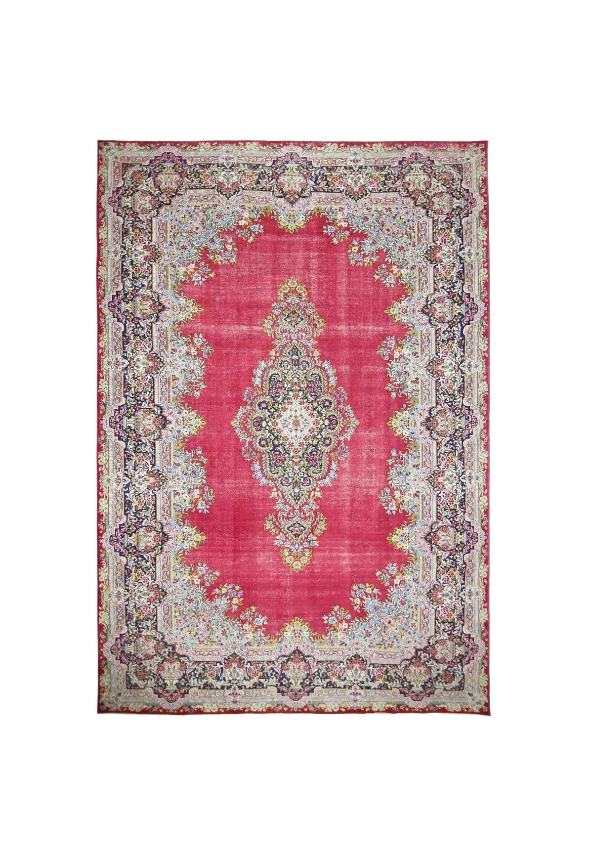 Vintage Persian Kerman rug featuring a central floral medallion and intricate curvilinear patterns in deep pink and blue.