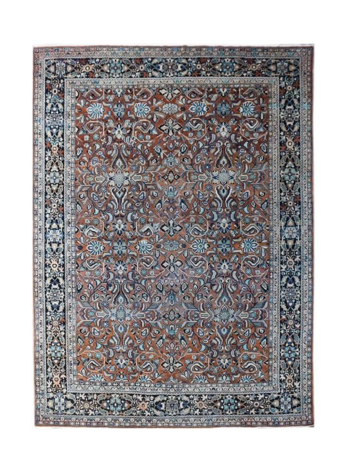 A vintage Persian Lori rug featuring a detailed floral pattern in rust, blue, and cream tones.