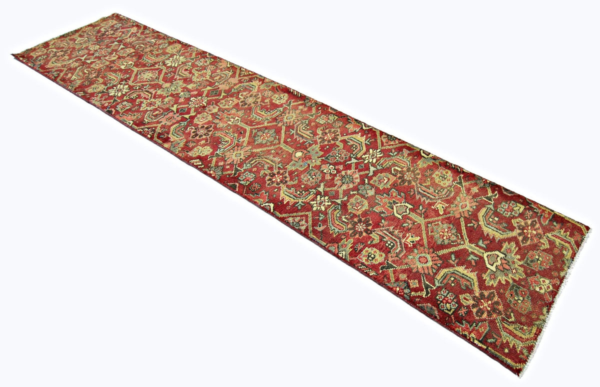 Vintage Persian Malayer runner featuring intricate floral and geometric patterns in rust red, sage, and indigo wool.