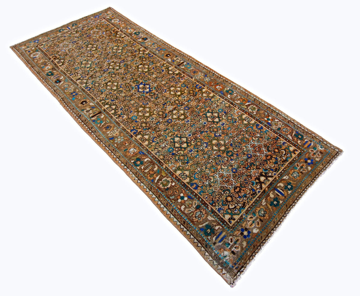 Vintage Persian Malayer runner featuring intricate floral and geometric patterns in indigo, rust, and sage on wool.