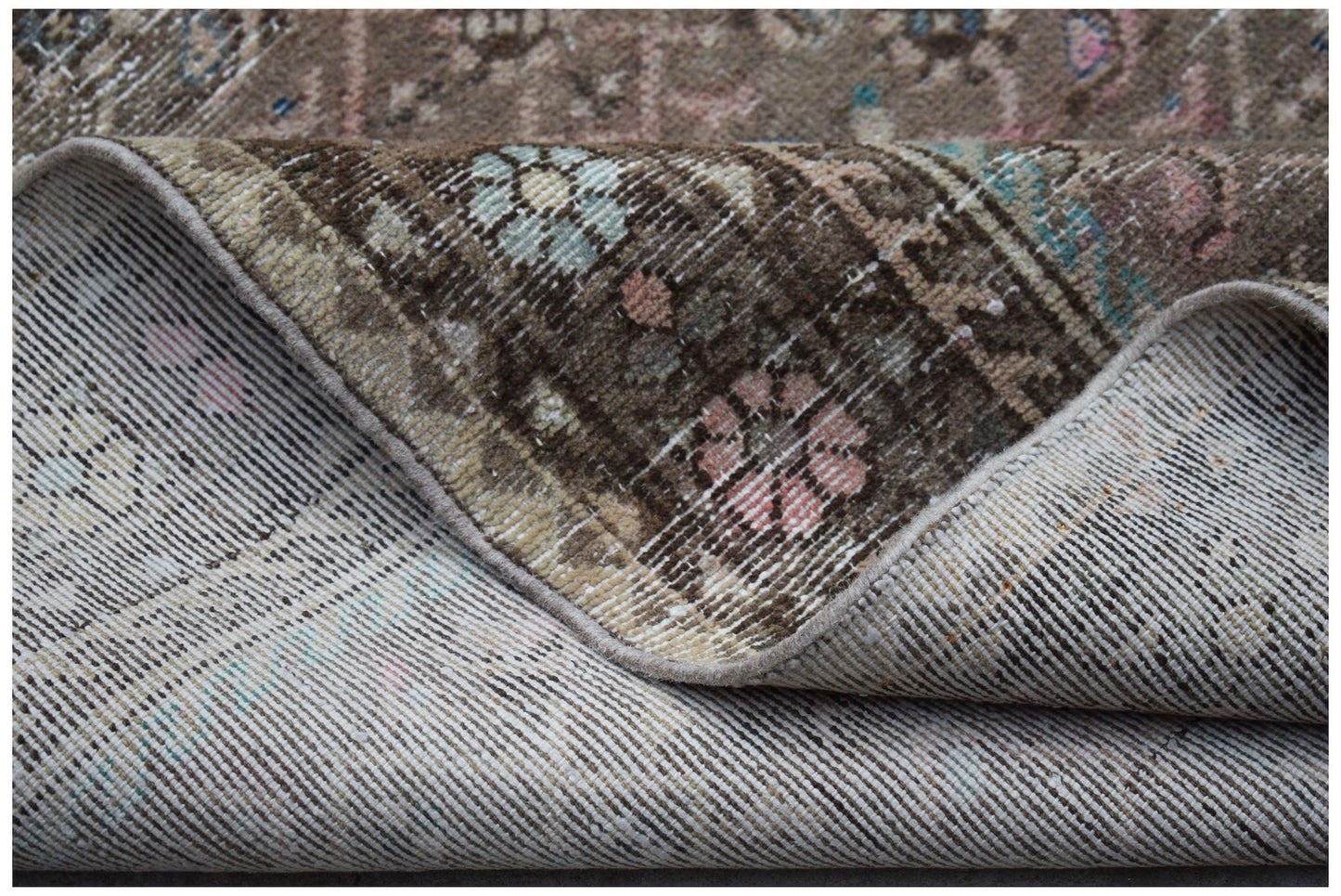A vintage Persian Hamadan runner with a worn floral pattern and visible cotton foundation.