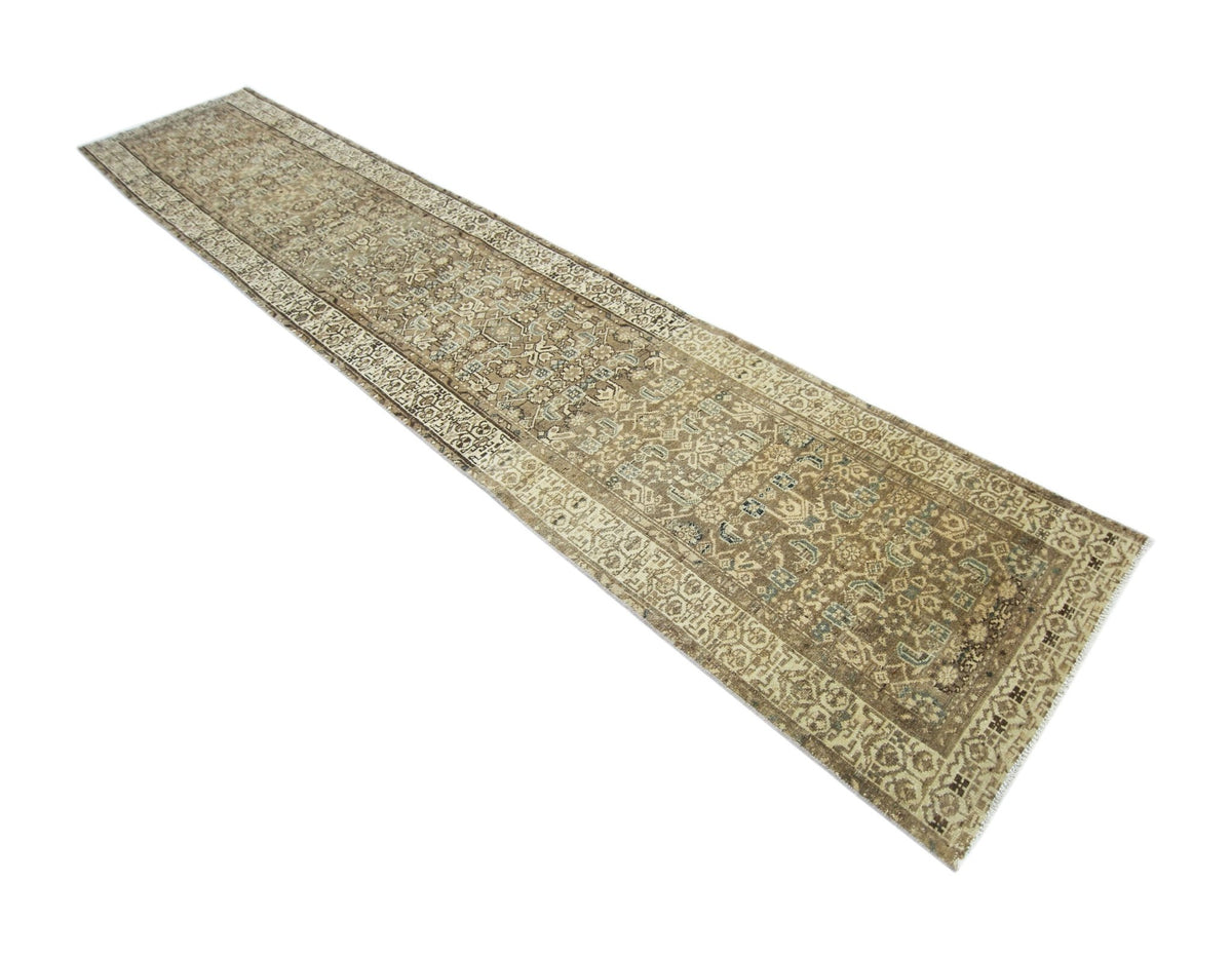 Vintage Persian Malayer runner featuring intricate floral and geometric patterns in muted earth tones on a low pile.