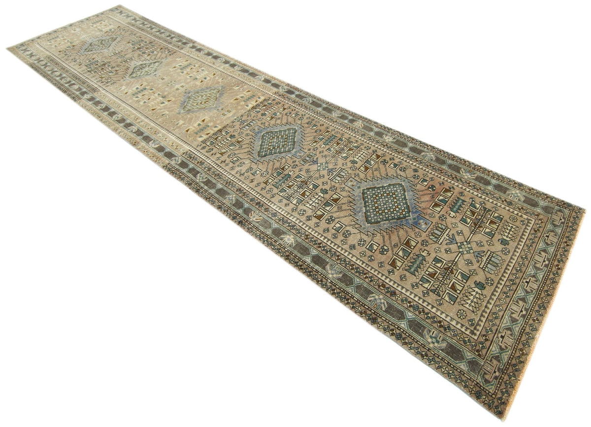 Vintage Persian Malayer runner with geometric medallions and intricate floral motifs in muted indigo, rust, and ivory.