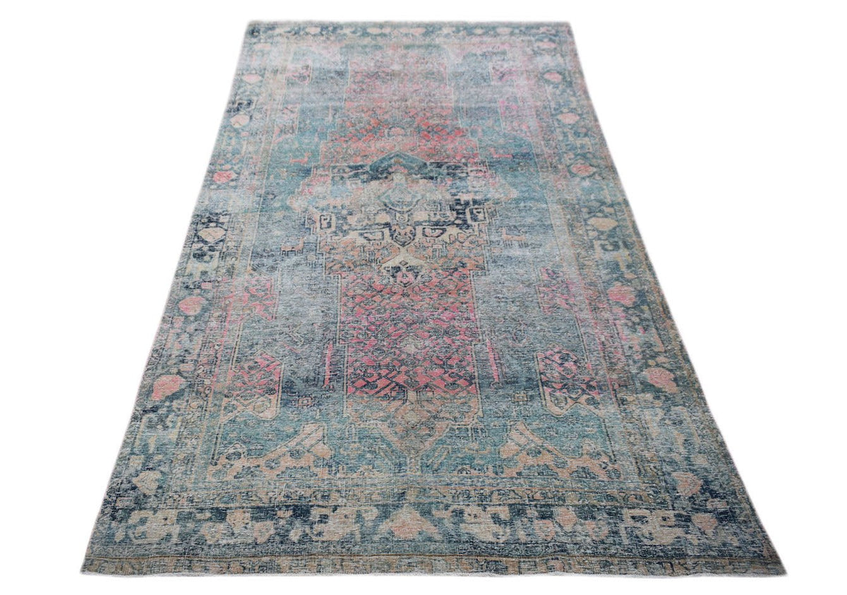 A vintage Persian Mazlaghan rug featuring a distressed blue and pink floral pattern.